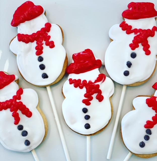 Snow man cake pops with red frosting hat and scarf